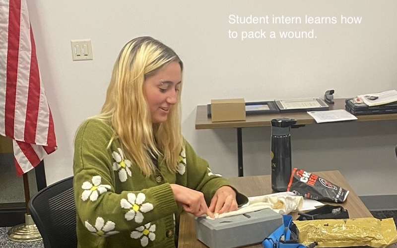 Student intern learns how to pack a wound