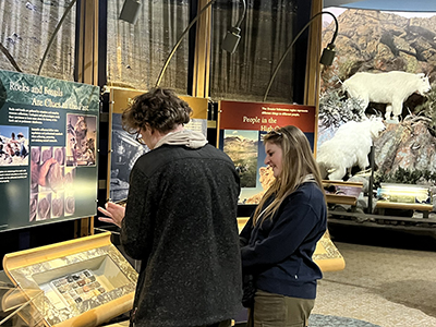 Two students looking at an exhibit in a museum